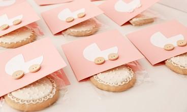 Image of a baby shower invitation and a cookie